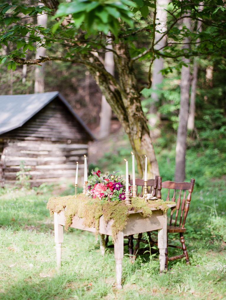 Outdoor sweetheart table with moss and by cabin | Styling by Mingle Events in Asheville NC