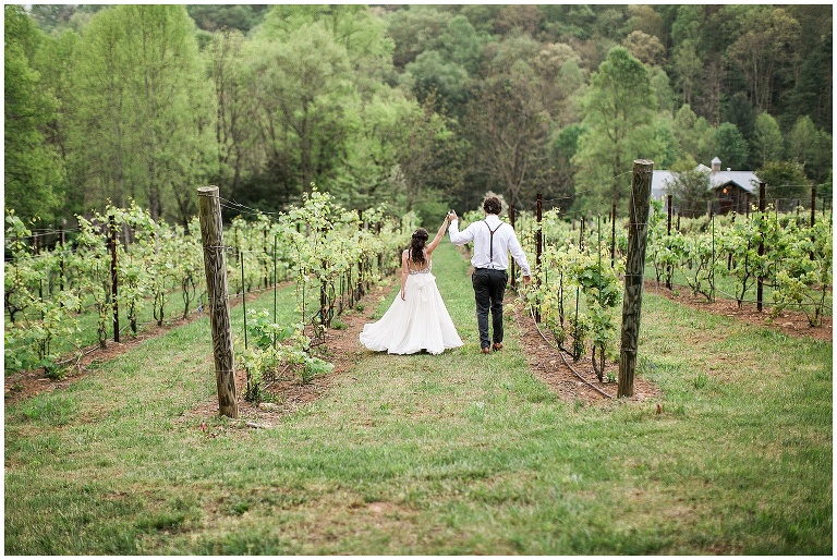 Bride and Groom walking through vineyards, Mingle Events couple